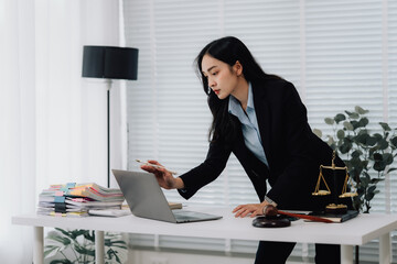 Attractive young lawyer in office Business woman and lawyers discussing contract papers with brass...