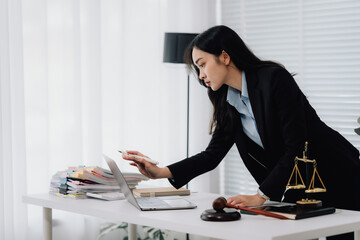 Attractive young lawyer in office Business woman and lawyers discussing contract papers with brass...