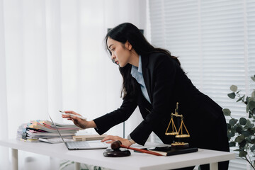 Attractive young lawyer in office Business woman and lawyers discussing contract papers with brass...