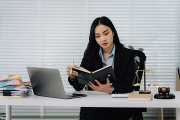 Asian Female Lawyer Reviewing Case Notes