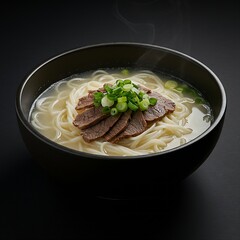 A bowl of seolleongtang 설렁탕  (ox bone soup) with thin noodles, sliced beef, and green onions, served in a black ceramic bowl against a black background