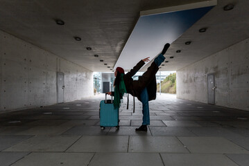 Woman traveler doing gymnastics in a tunnel in Stuttgart.