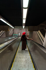 Woman using escalators stairs in the Stuttgart airport subway station