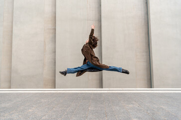 Young woman doing split mid-air on the streets of Stuttgart city