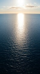 Obraz premium Ocean's Embrace: Illuminated by the Sun