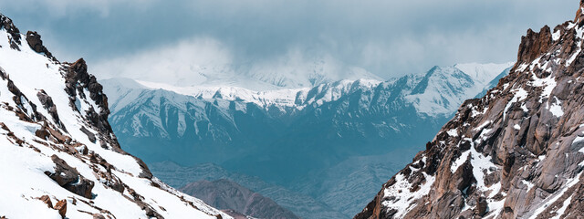 Majestic snow-capped Himalayan mountains near Leh under clear blue sky, showcasing stunning natural...