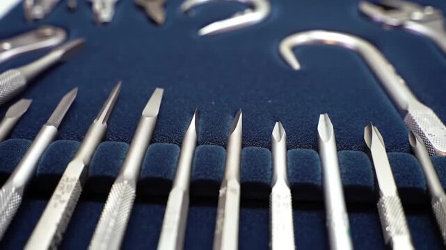 Close-up shot of a set of various metal tools arranged in a blue case.