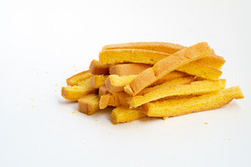 Dried crust strips from sliced white bread, collected as leftover edges. Once discarded, these golden pieces are now repurposed for crunchy snacks or toasted garnishes.