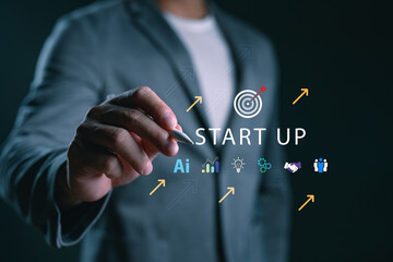 Entrepreneur hand with digital pen writing startup concept with AI, growth chart, teamwork, and...