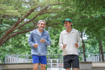 bonding father and son jogging in the park,family relationship,togetherness
