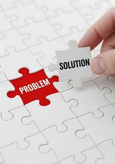 Hand placing solution puzzle piece over problem jigsaw