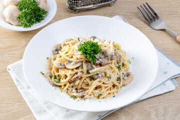 Spaghetti with Mushroom Cream Sauce in White Ceramic Plate
