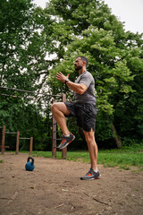 Handsome man  maintaining physical strength by exercising in nature 