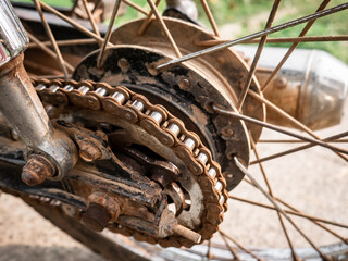 Close up of a rusty motorcycle chain and sprocket