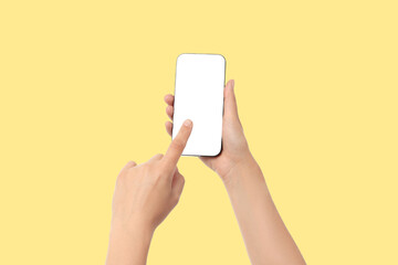 A person points at a blank smartphone screen in bright yellow