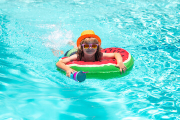 Happy child playing in swimming pool. Summer kids vacation. Summer kids vacation fun. Kids swimming...