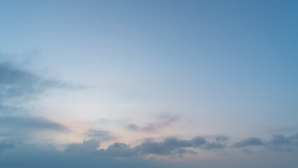 A serene sky with light clouds during twilight hours