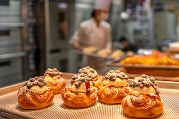 Delicious pastries with cream and toppings in a bakery setting