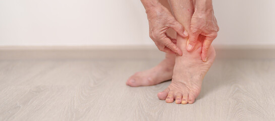Elderly woman having leg pain due to Ankle Sprains or Achilles Tendonitis and Shin Splints ache....
