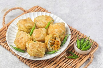 Tahu Isi. Stuffed tofu is known as fried food in the form of brown tofu filled with various...