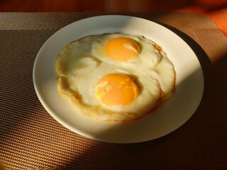 View of fried egg at table with blurred background. Food photography concept design.