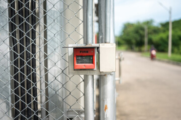 Fire alarm activate switch which is installed on fence wall, outside the factory place. Using in...