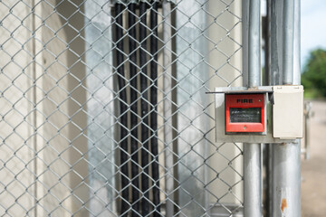 Fire alarm activate switch which is installed on fence wall, outside the factory place. Using in...