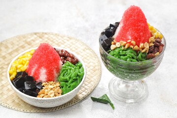 Ais kacang is a dessert that is quite popular in Malaysia and Singapore which contains cendol, red beans, chopped fried peanuts, black grass jelly and red syrup