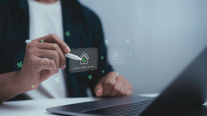 Businessman using laptop and stylus with digital house and percentage icons, representing real estate investment, mortgage loan, housing market, property finance and interest rate concept