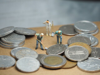 Fototapeta premium Mini toy at table with blurred background. Financial and economic photography concept design.