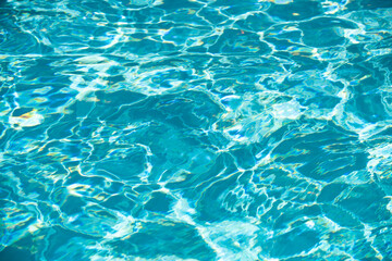 Fototapeta premium Ripped water in swimming pool. Surface of blue swimming pool, background of water.
