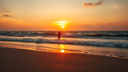 Obraz premium Sunset at the beach with golden light and distant silhouettes of a family.