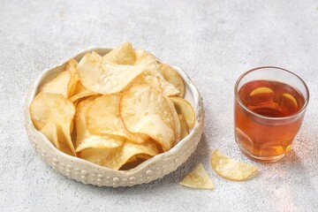 Keripik Singkong. Cassava chips are a snack or treat made from thin slices of cassava that are...