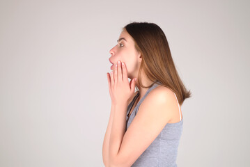 Beautiful female portrait isolated on studio backgroud. Emotional surprised woman facial expression...