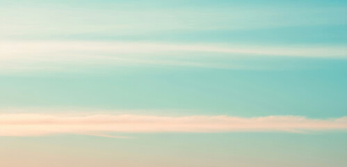 Abstract blurred background with teal blue and light beige colors, creating a soft dreamy atmosphere that feels calm and natural with smooth gradient tones.