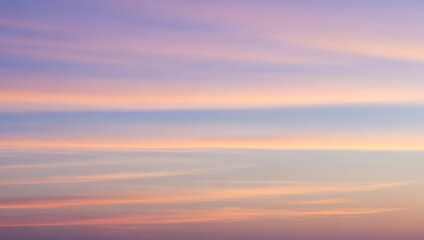 Fototapeta premium Sky with pastel colors showing pink purple and blue light cloud formations, presenting a dreamy tranquil scenery with delicate tones across the horizon.