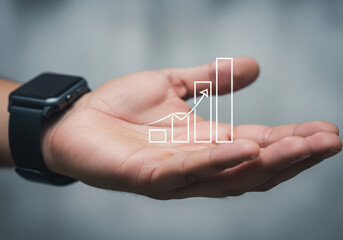 Hand holding holographic bar chart showing business growth and financial success concept