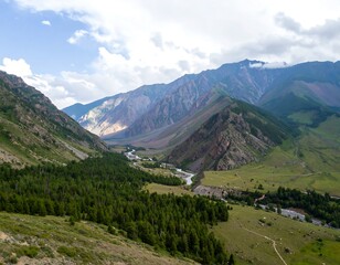 Fototapeta premium Mountain valley landscape with river and clouds