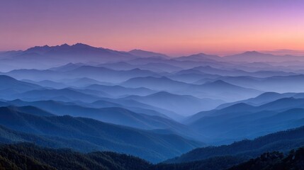 Obraz premium Serene sunset over layered, hazy mountains