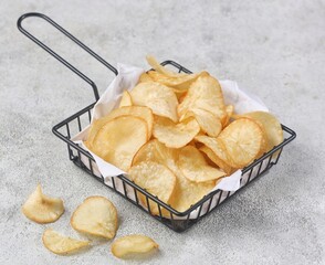 Keripik Singkong. Cassava chips are a snack or treat made from thin slices of cassava that are...