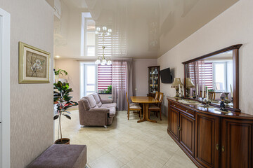 cozy living space featuring a plush sofa, wooden dining set, and dark wood furniture with a large...