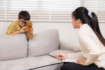 Therapy, child, counseling, psychologist, emotion reflected in withdrawn posture, boy holding...