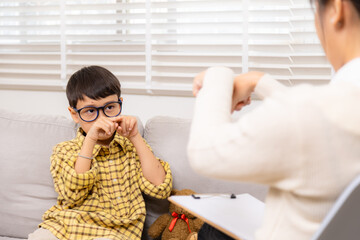 Therapy, child, counseling, psychologist, emotion reflected in withdrawn posture, boy holding...