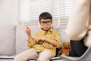 Therapy, child, counseling, psychologist, emotion conveyed through gentle interaction as female...