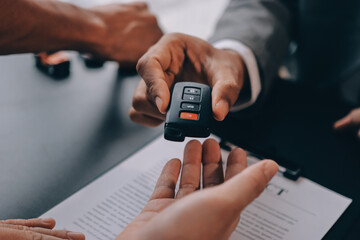 Car salesman gave the keys to the customers who signed the purchase contract legally, Successful...
