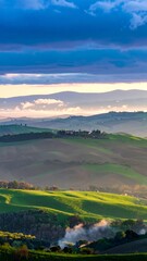 Rolling hills bathed in sunrise, mist clinging to valleys