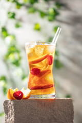Peach Raspberry iced Tea in galss. Summer refreshing drink
