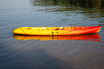 Yellow and orange kayak floating on clear Adriatic Sea water, photographed in Croatia, showing...