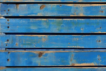 Horizontal lines of weathered, deep blue painted wood planks, exhibiting a rustic charm.