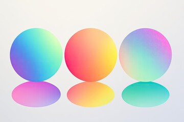 Three vibrant, ombre spheres, in pastel colors, resting on reflective surfaces